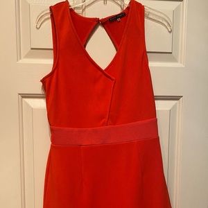 Flirty orange dress with cut out back.